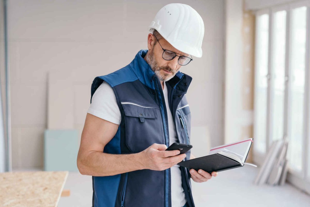 builder-using-smartphone-shutterstock